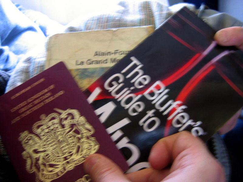 A passport, a book and a guide to wine. Proper tourists